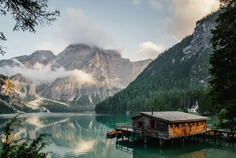 El lago con las montañas de fondo y un muelle de madera